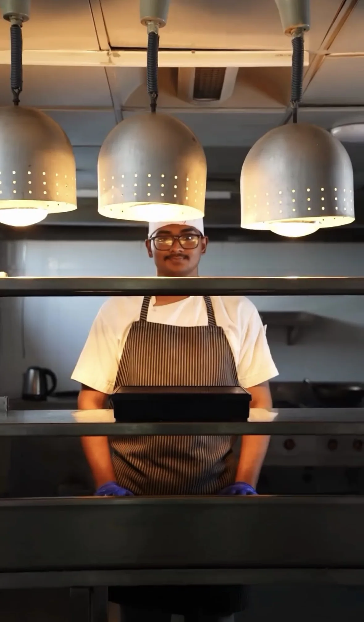 Chef Antony Jeno Raj at the pass in a professional kitchen